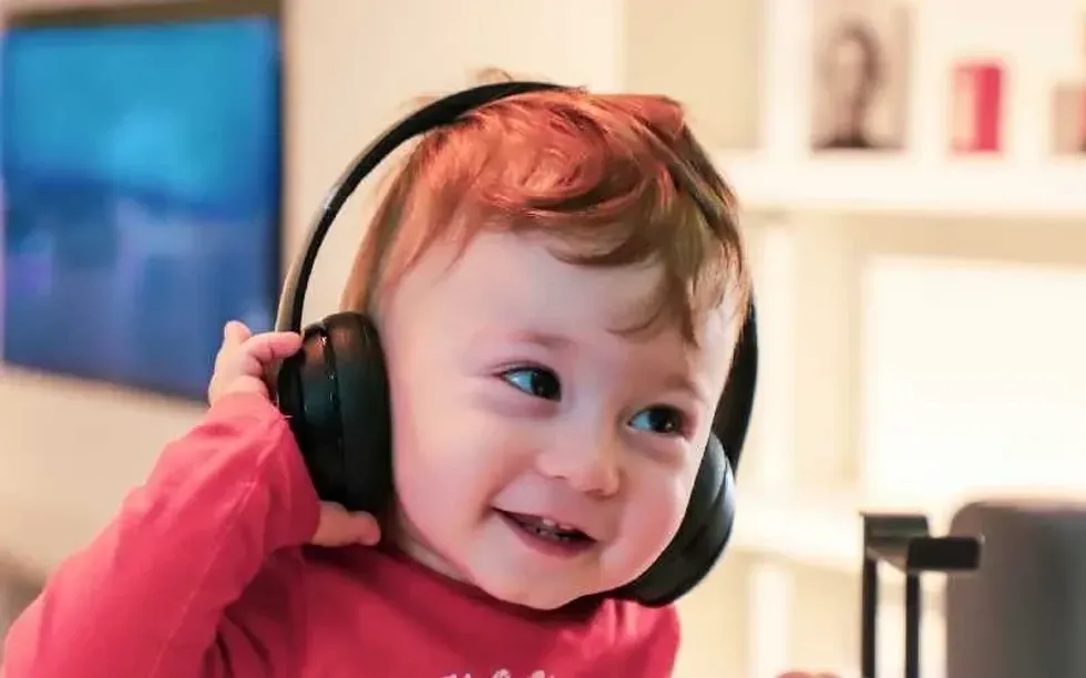 Baby boy listening to music on headphones