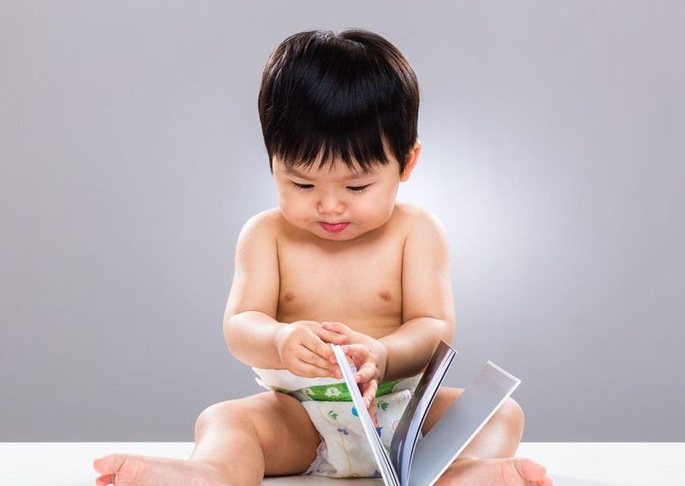 Baby boy reading book