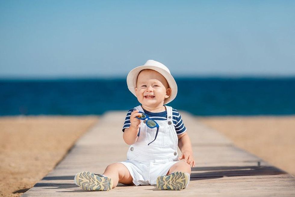 Baby boy sitting on a beach side