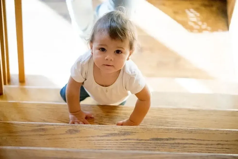 Baby crawling up stairs. 