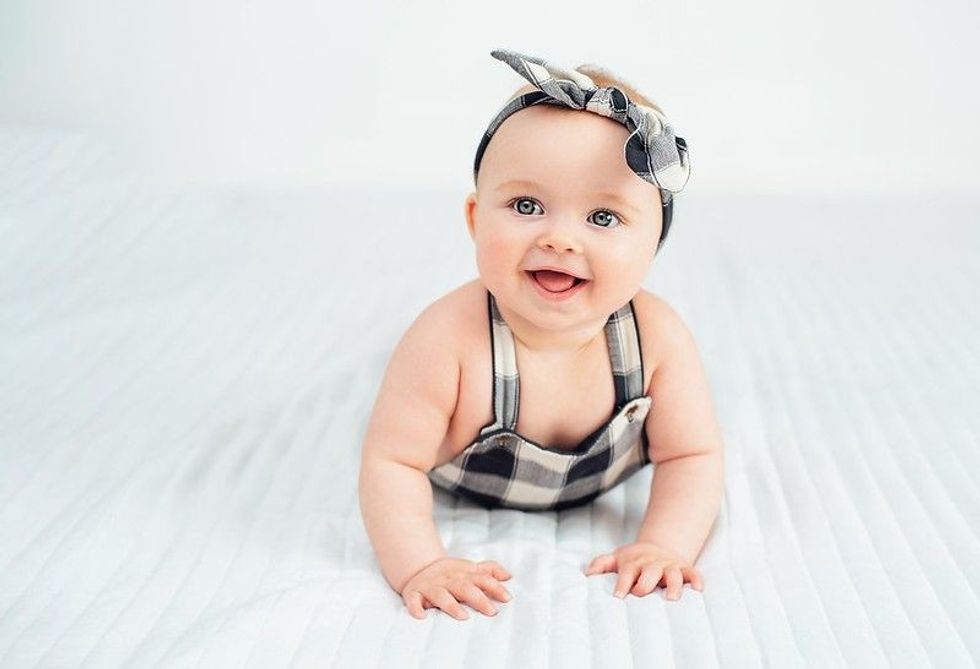 Baby Georgia wearing a bow headband smiling - Nicknames