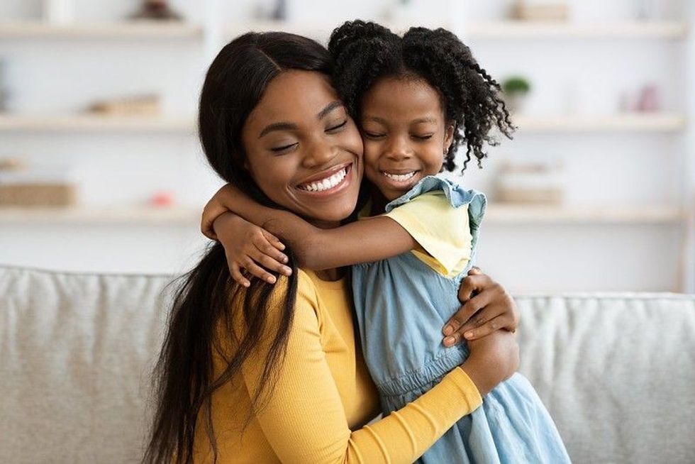 Baby girl hugging her mother