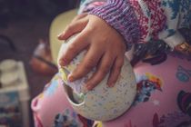 Baby holding hatchimal egg