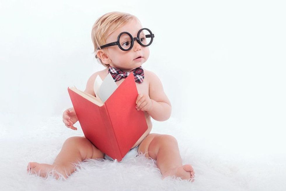 Baby reading a book.