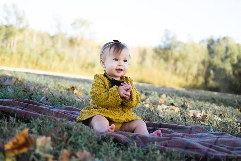baby sitting on the grass