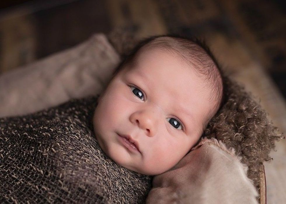 Baby wrapped in an all-brown blanket