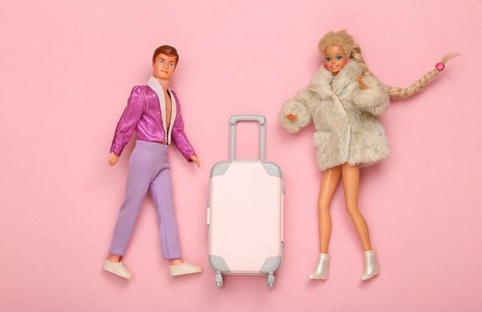 Barbie and ken dolls in fur coat and shoes with luggage