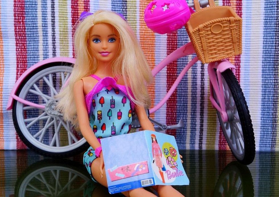 Barbie doll reading a magazine