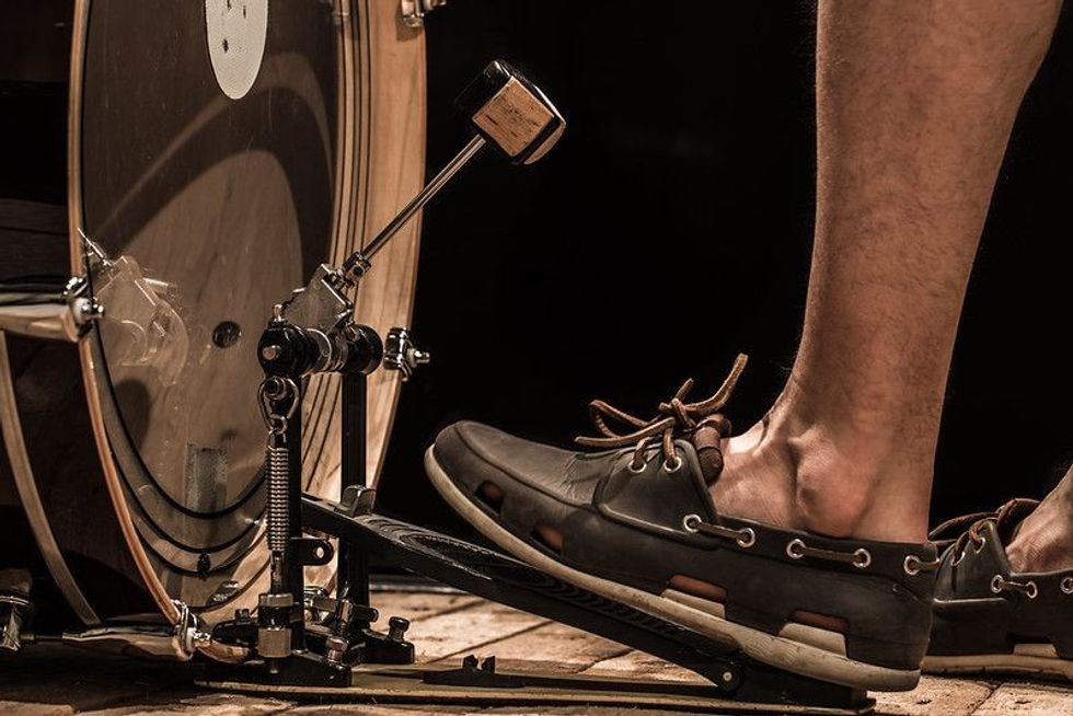  bass drum with pedal on wooden Board with black background