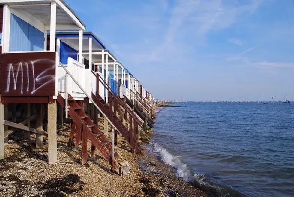 Beach huts with stairs leading into the sea.