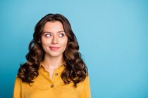 Beautiful girl wearing yellow dress and blue background