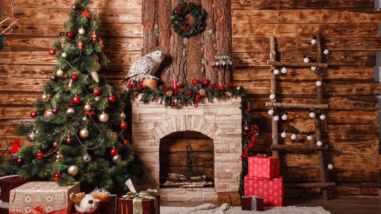 Beautiful New Year's interior with Christmas tree, fireplace and gifts.