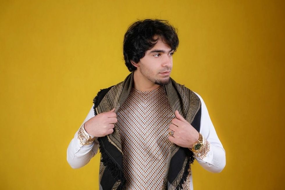 Beautiful photo of an Afghan boy in traditional Afghani clothes