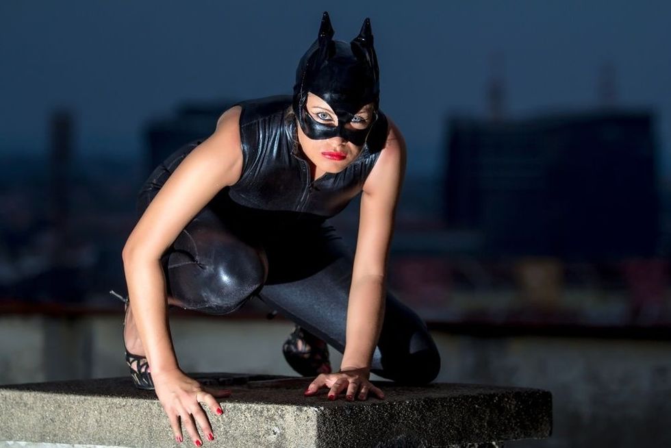 Beautiful woman in catwoman leather latex on the roof