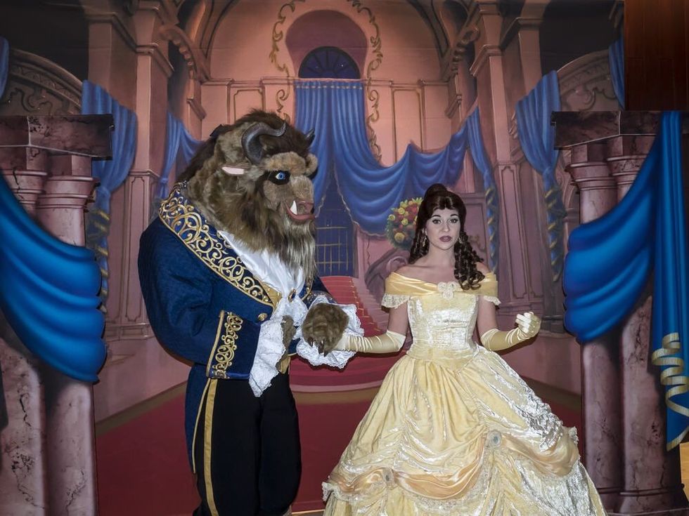 Beauty and The Beast characters pose for a photo at the 'Beauty and The Beast' 25th Anniversary Screening