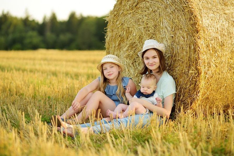 Big sisters and their baby-brother having good time.