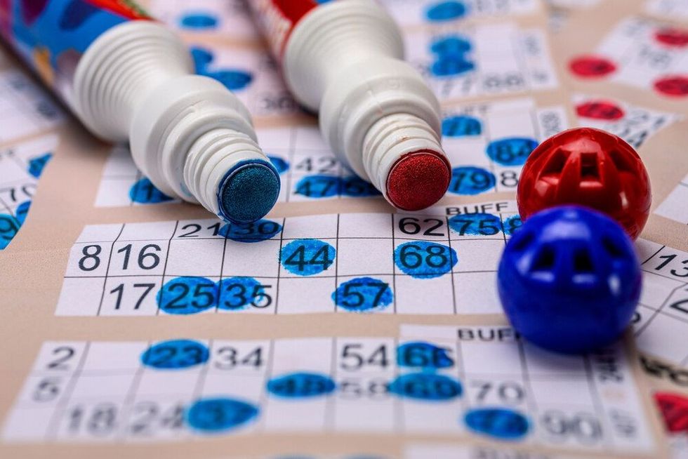 Bingo cards with red and blue markers close up
