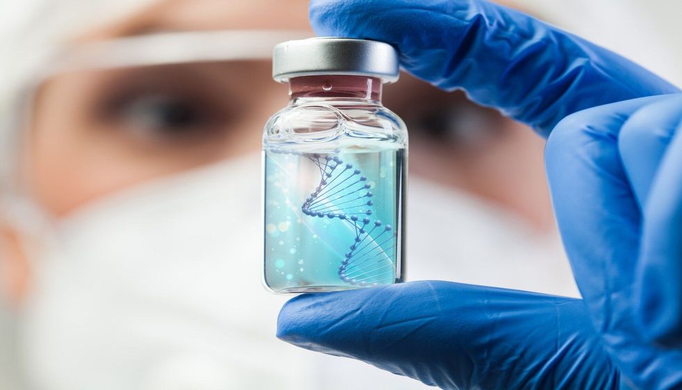 Biotechnologist holding glass ampoule vial with DNA strand.