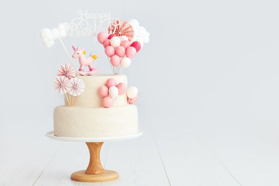 Birthday cake with unicorn and balloons