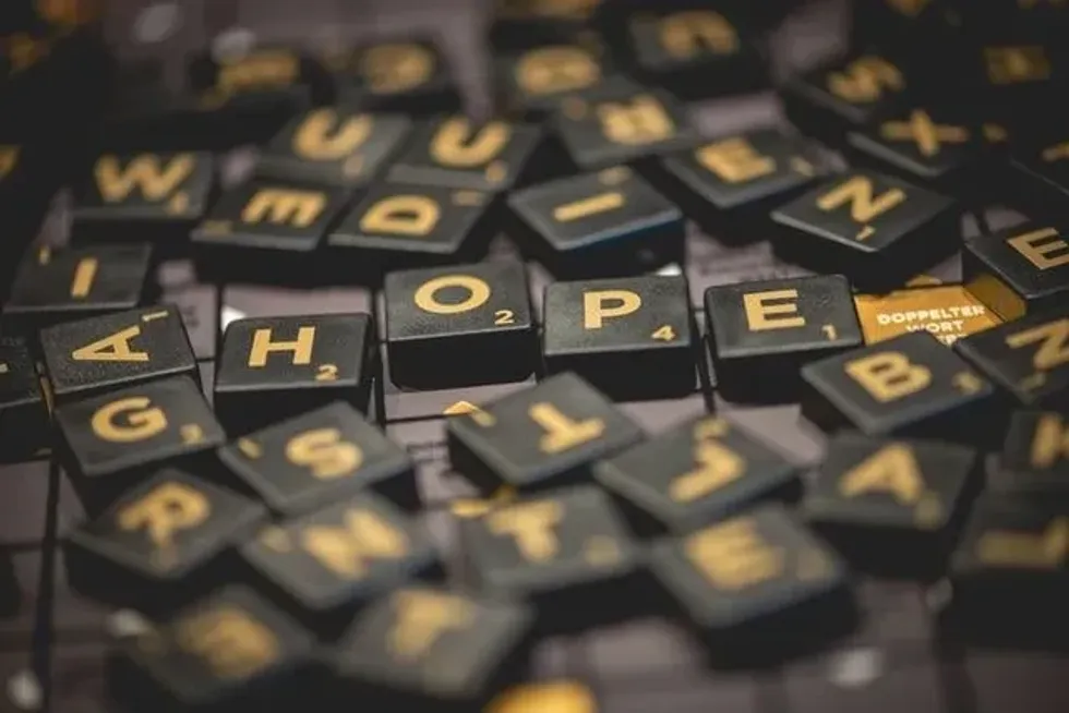 Black and gold alphabets of scrabble game scattered