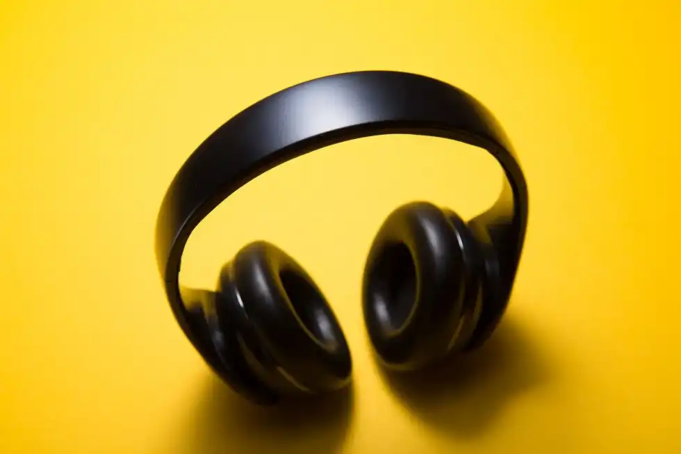Black headphones on yellow background