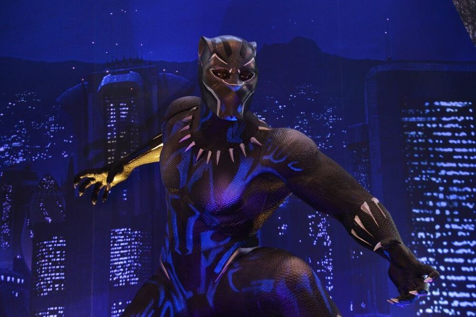 Black Panther Model With A Standee of A Marvel Superhero Movie Black Panther Display at the theater.