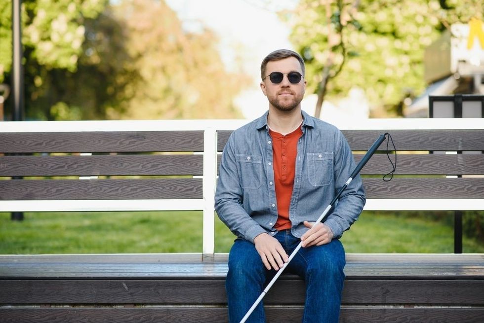 Blind man sitting on a bench