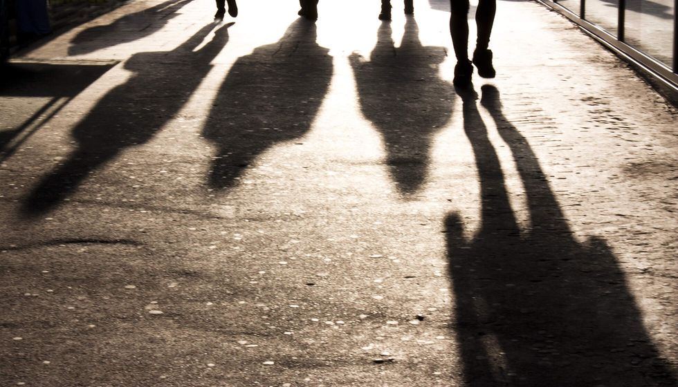 Blurry shadows of people walking towards the camera.