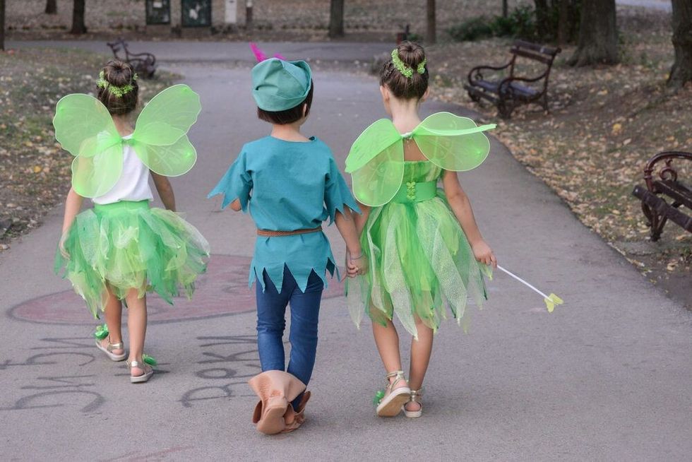 Boy dressed as Peter Pan and two girls dressed as fairies