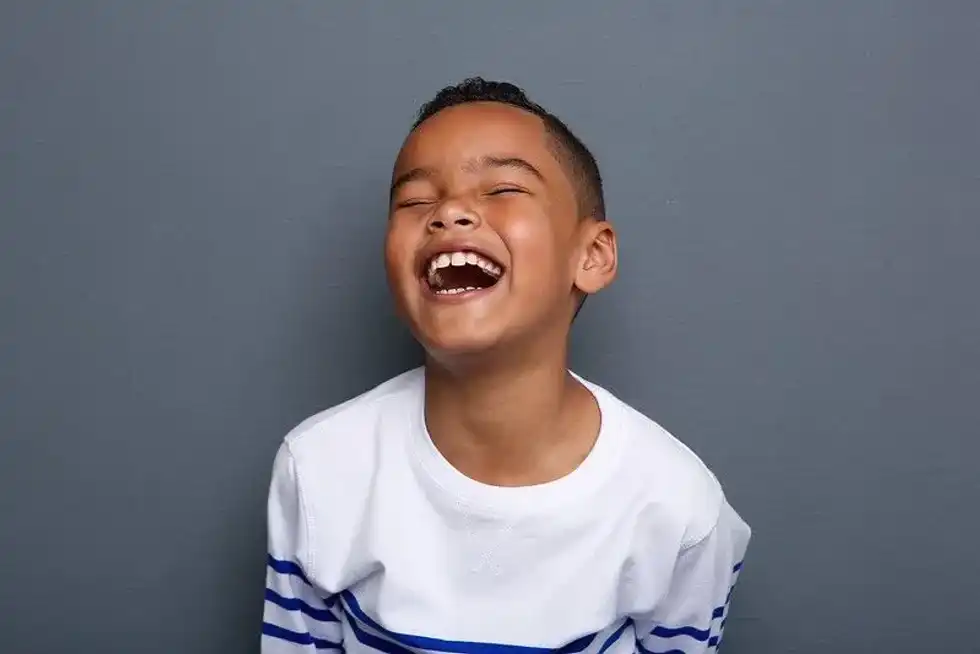 Boy laughing at lockdown jokes