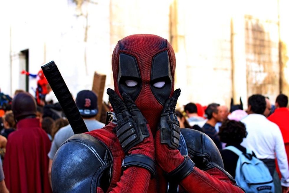 Boy masked by the superhero Deadpool at Lucca Comics and Games.