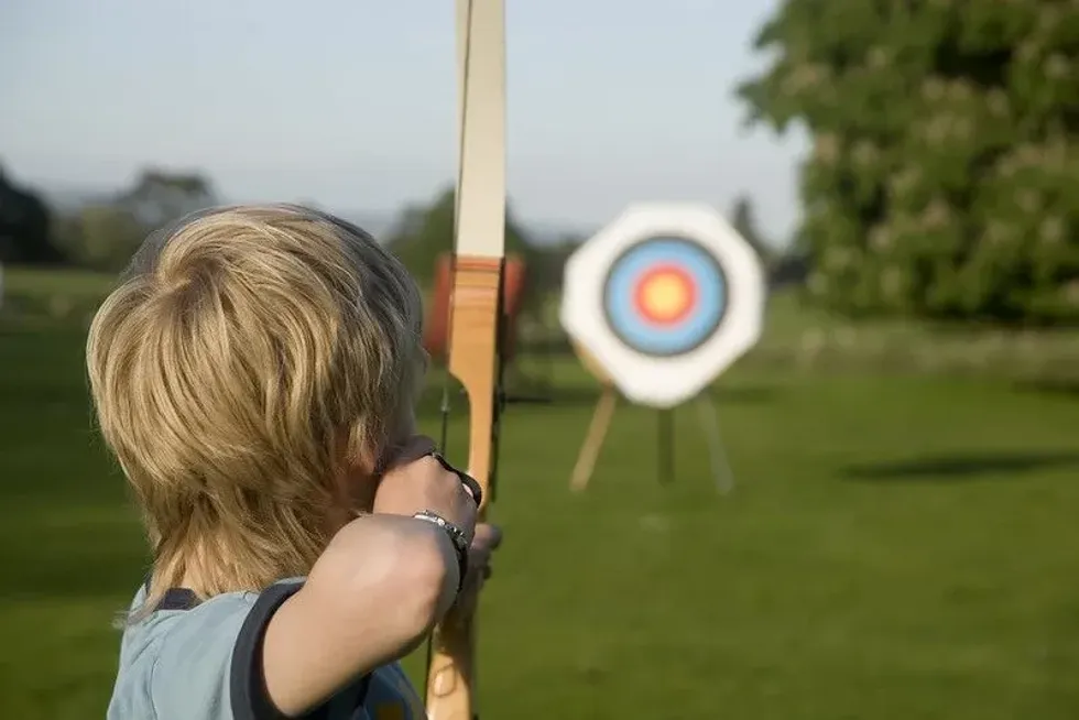 Boy taking part in archery