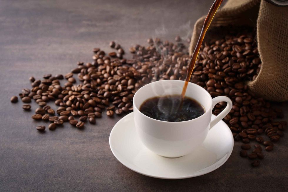 Brewed coffee pouring in a cup.