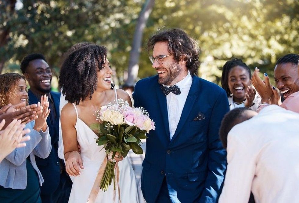 Bride and groom enjoying their wedding surrounded with family and friends.