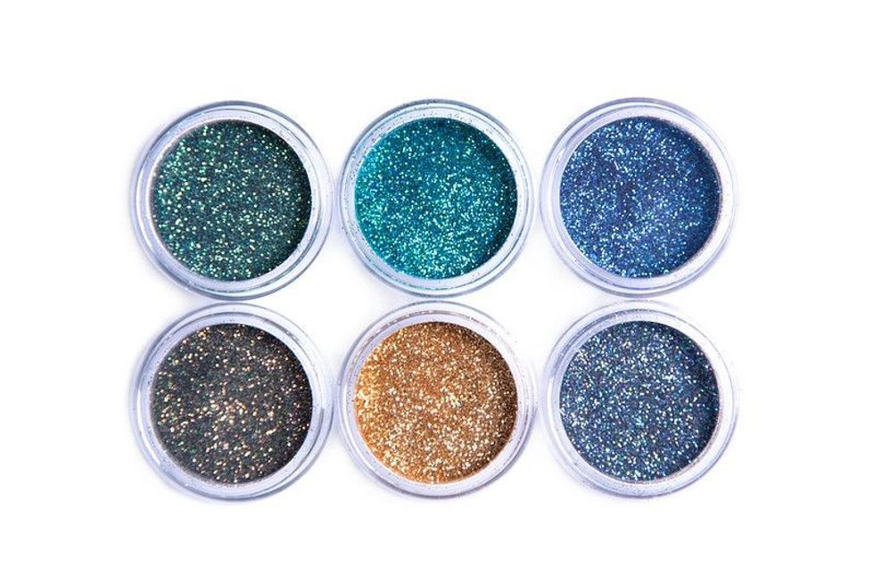Bright cosmetic glitters in transparent jars.