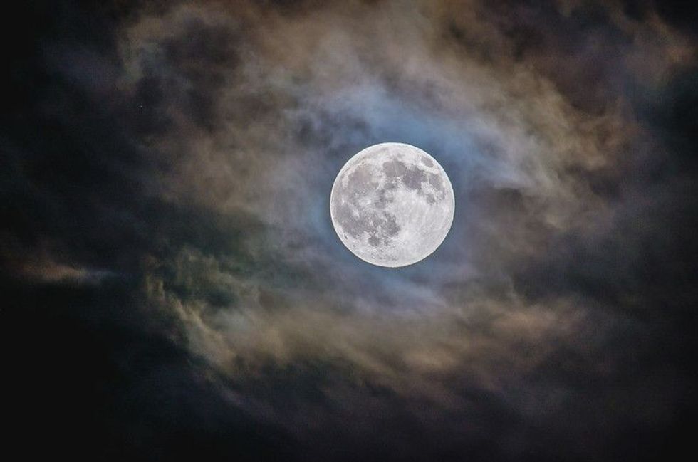 Bright full moon with cloudy background at the nighttime
