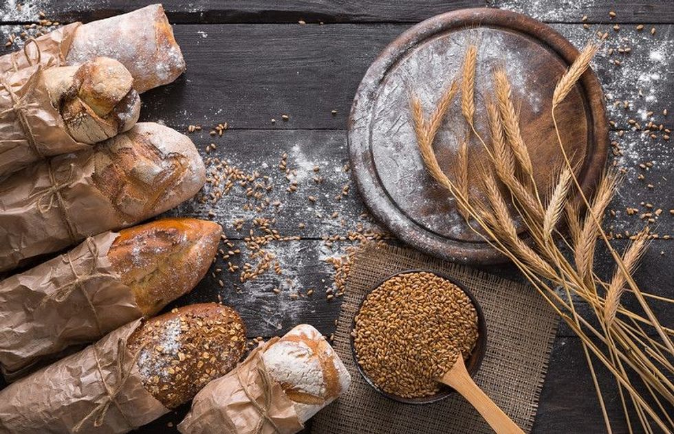 Brown and white whole grain loaves wrapped in Kraft.