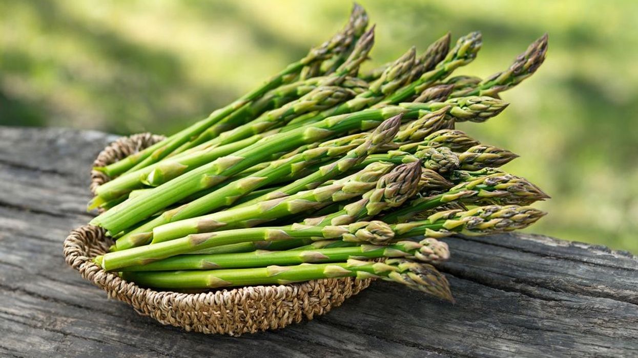 Bunches of green asparagus in basket