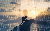 Businessman reaching for success and overcoming obstacles