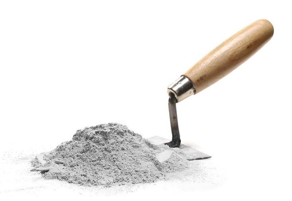 Cement pile and trowel isolated.