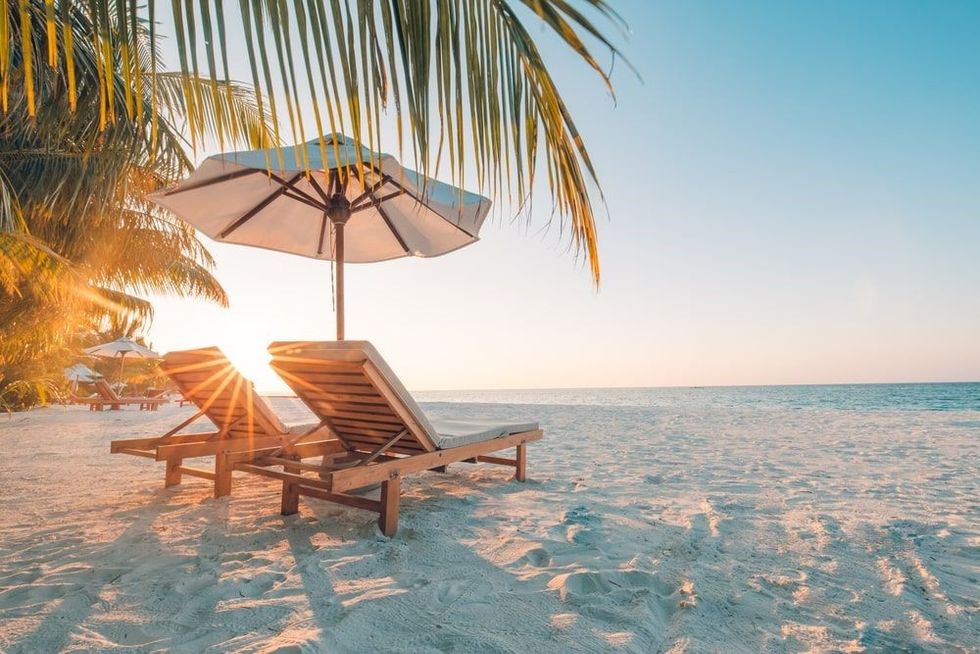 Chairs on the sandy beach near the sea.