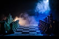 Chess figures on a dark background with smoke and fog.