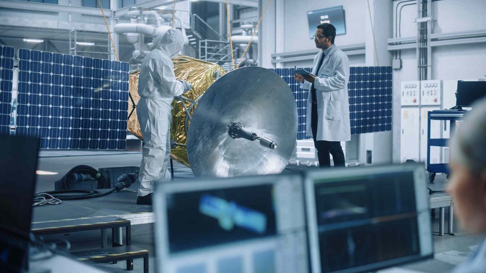 Chief Technician Working on Satellite.