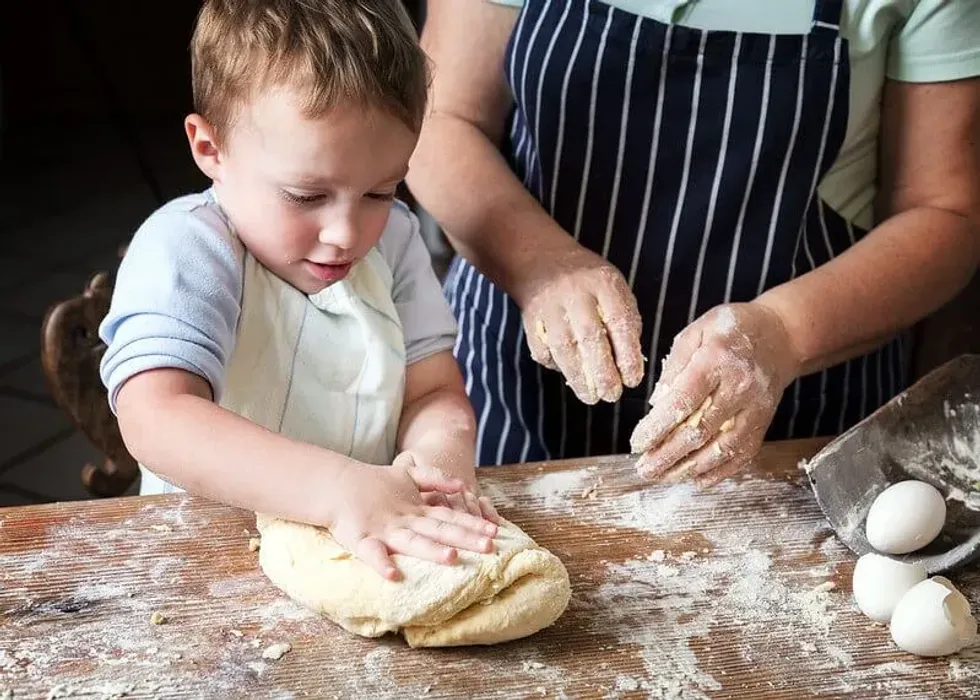 Child and father making bread