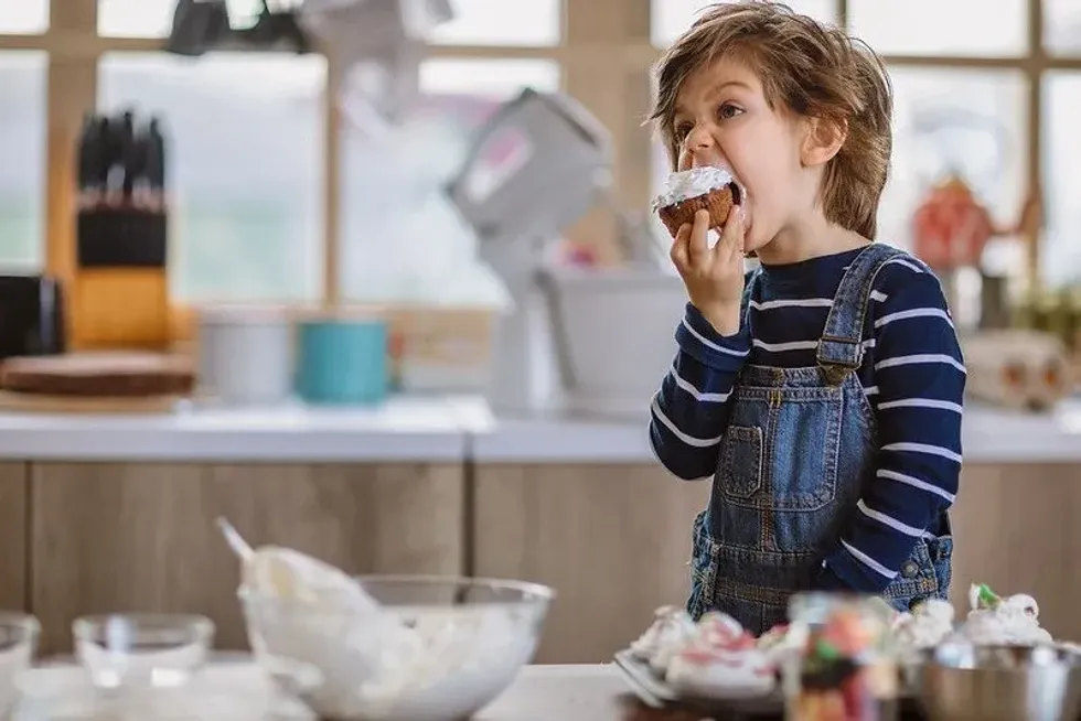 Child eating a homemade nut-free cupcake.