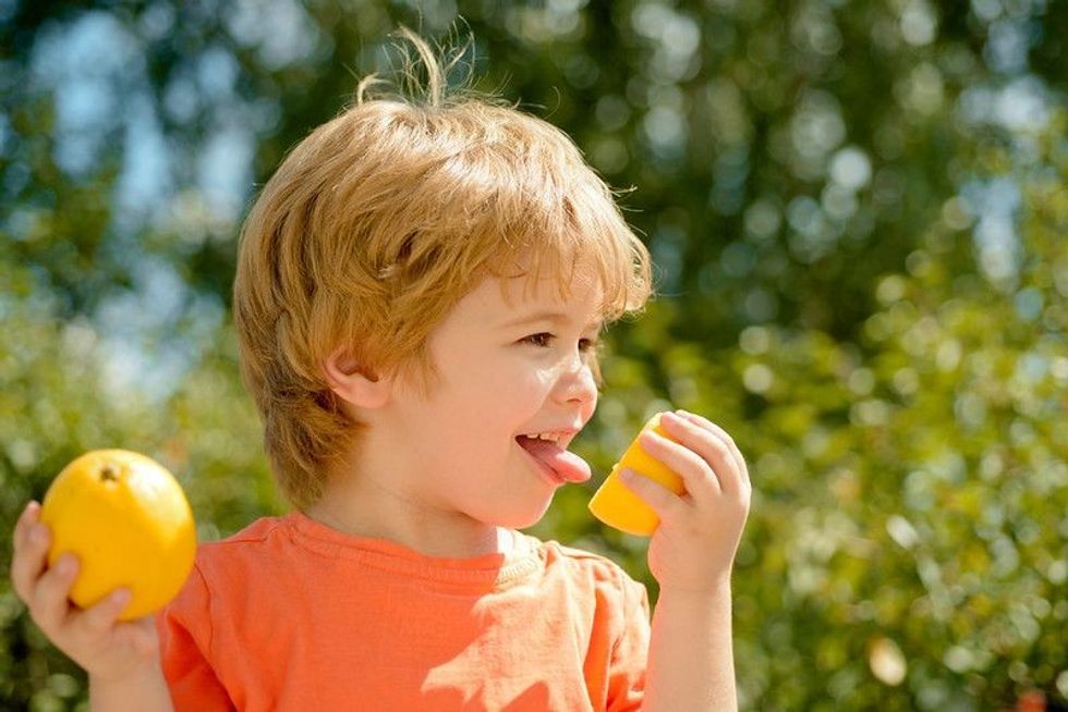 Child eats sour fruit