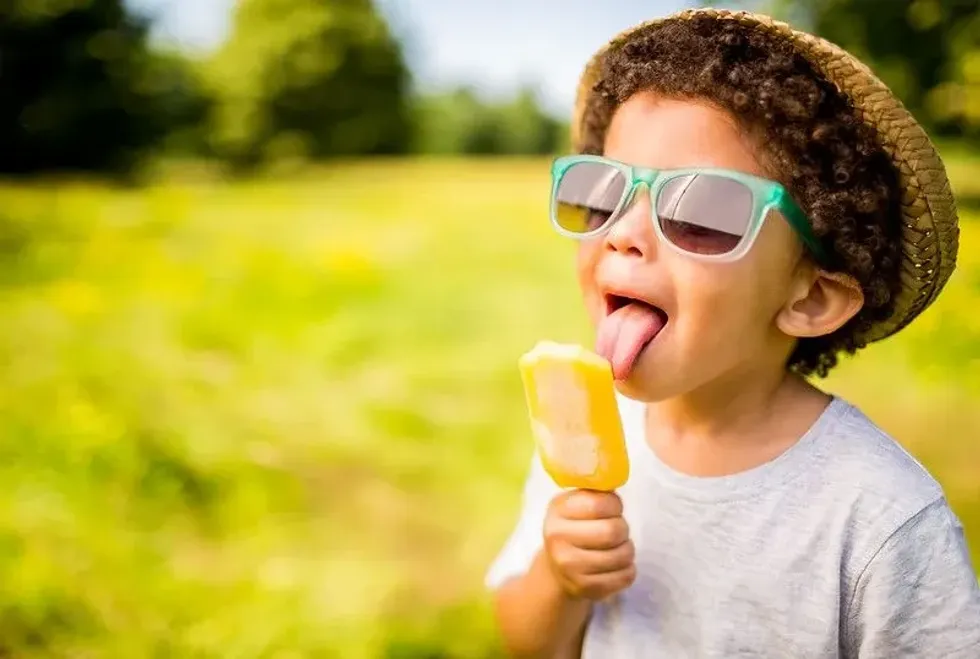 Child enjoying a homemade ice lolly in the garden.