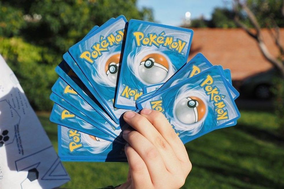 child holds some pokemon cards - Nicknames