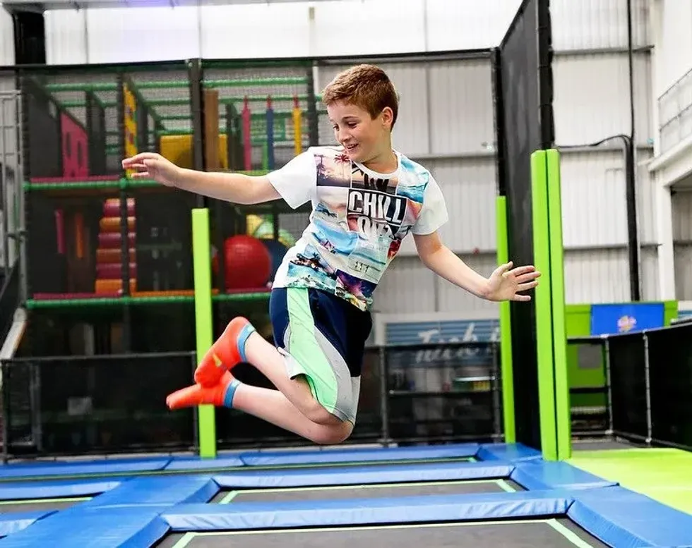 Child jumping on trampoline.