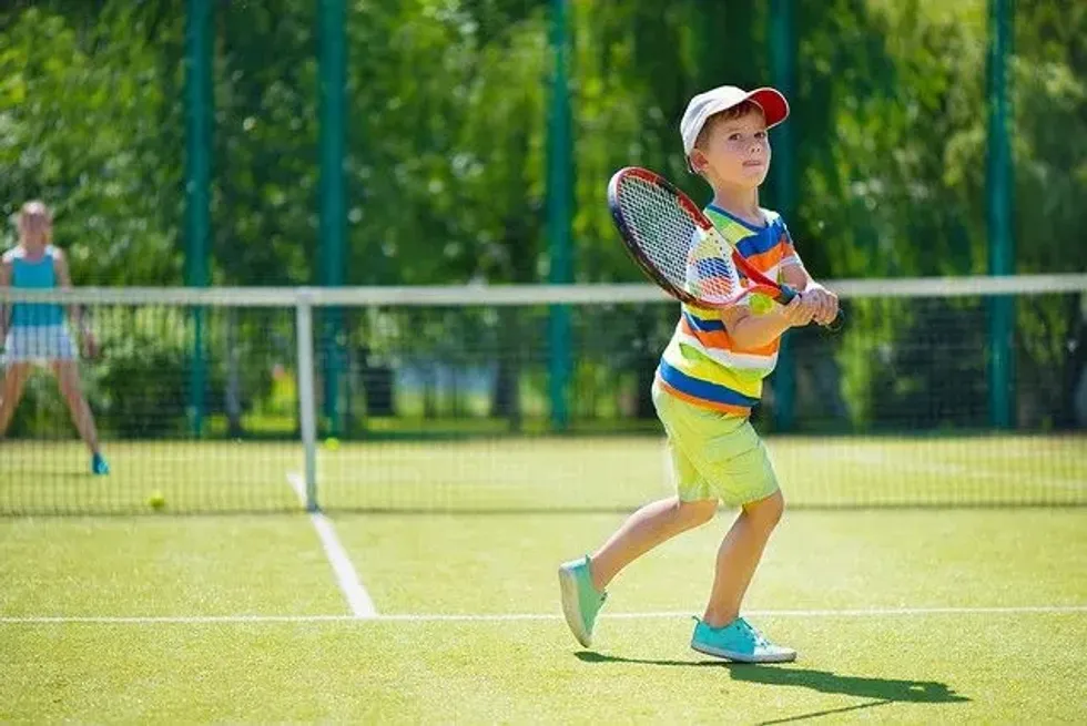 child playing tennis.